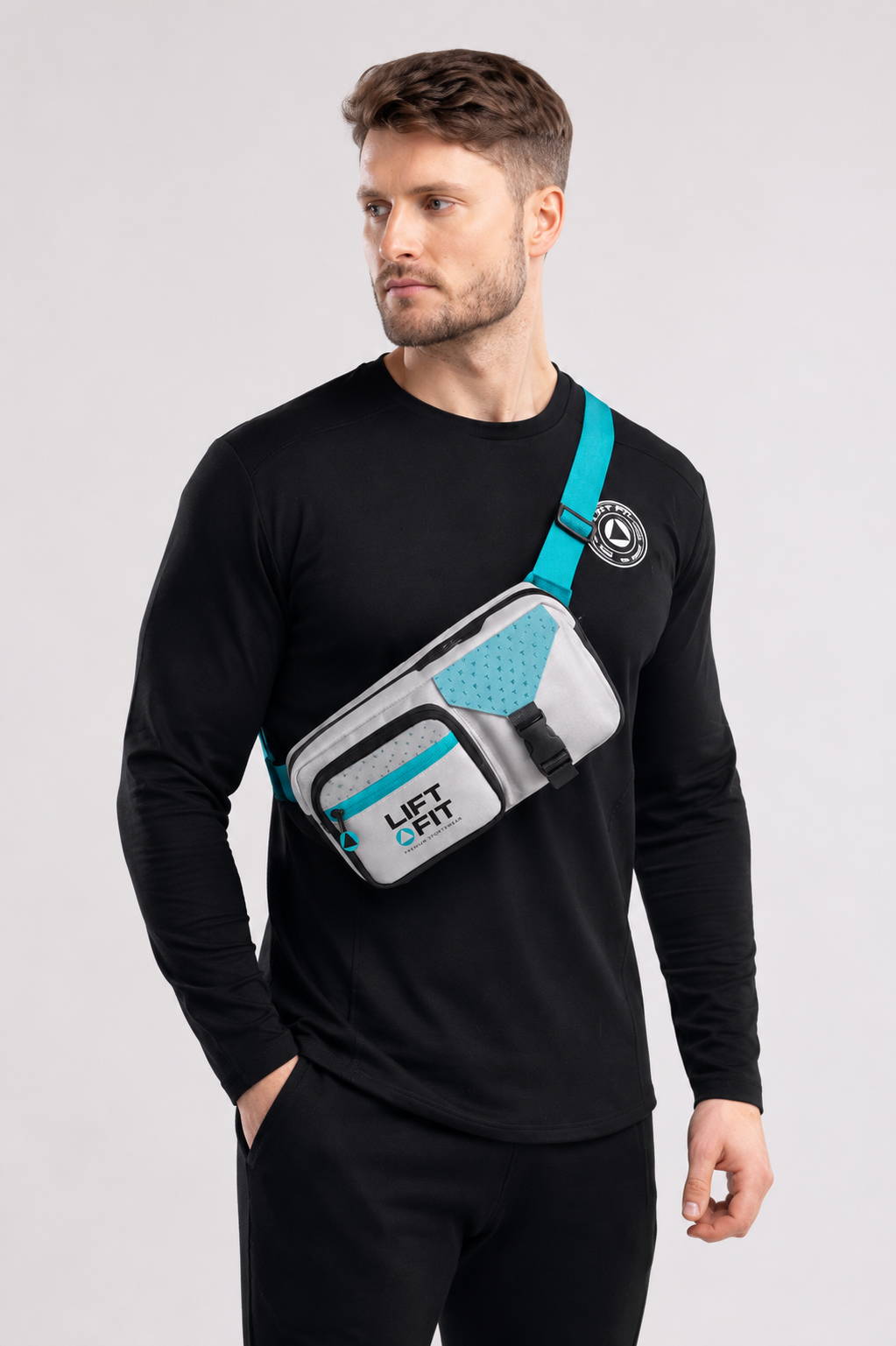 Man wearing LF Crossbody Bag in grey and turquoise across chest with quick-release buckle — LIFT FIT